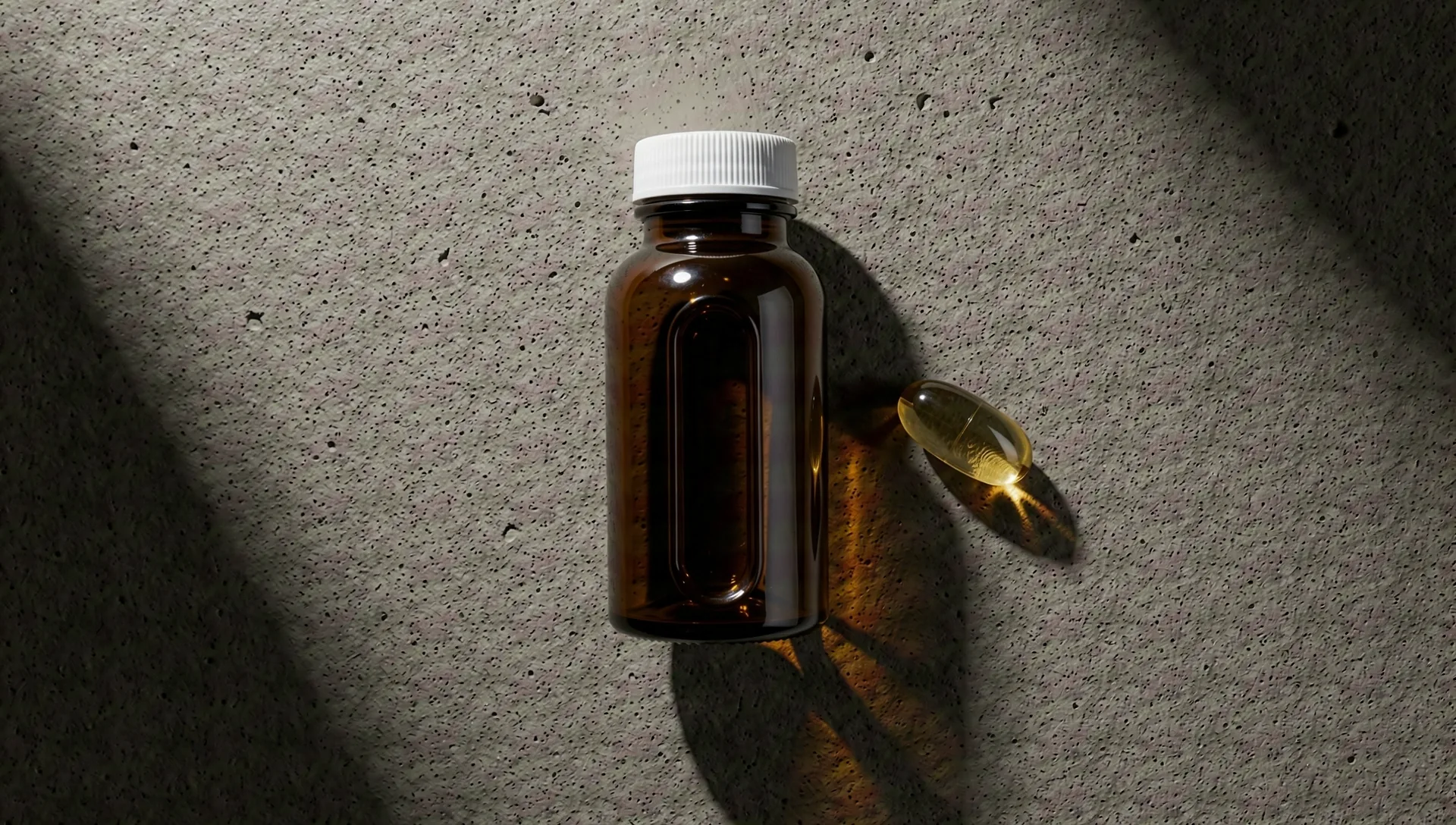 Male vitality supplement bottles on stone